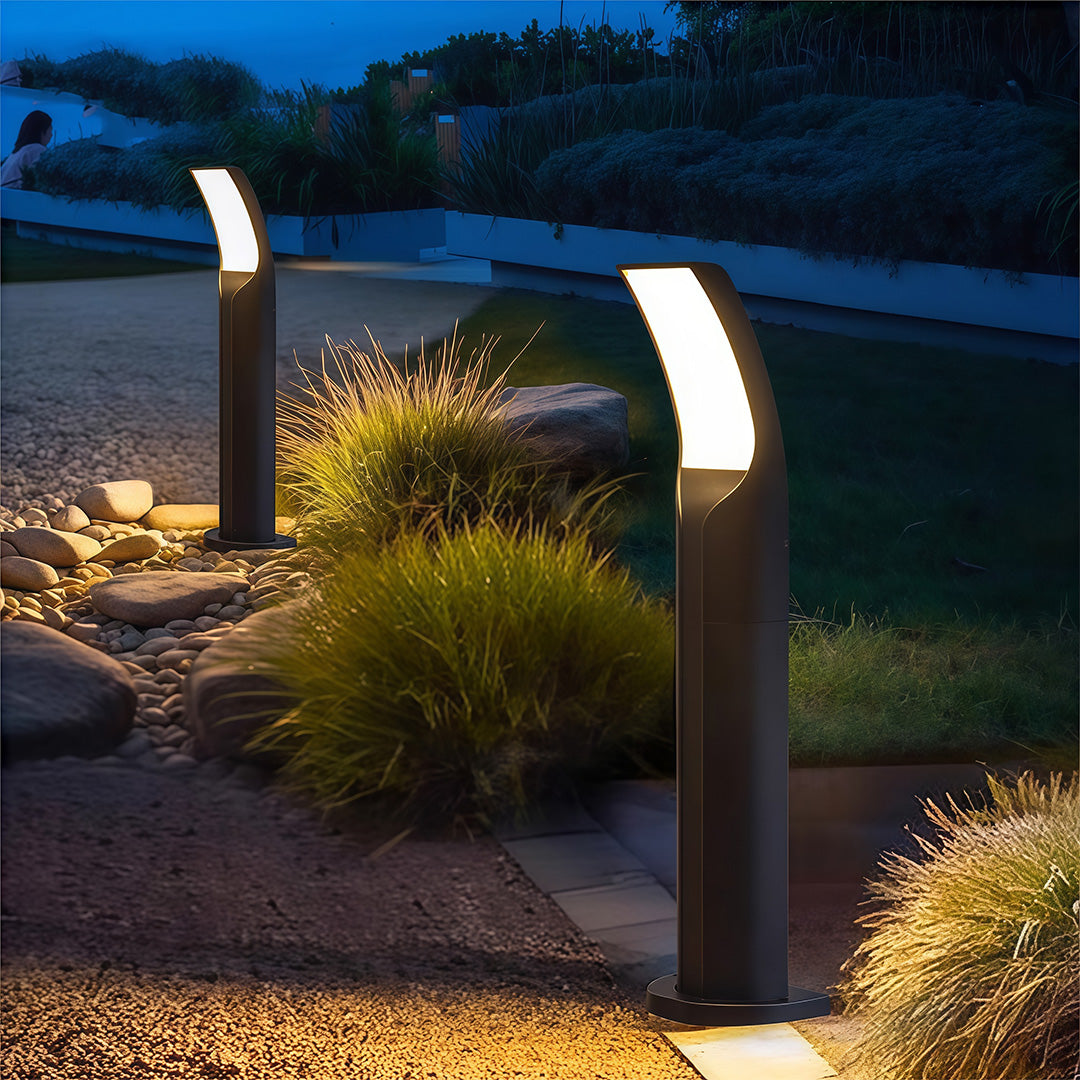 Modern black wall-mounted light in the garden, providing an elegant touch with subtle, warm lighting.