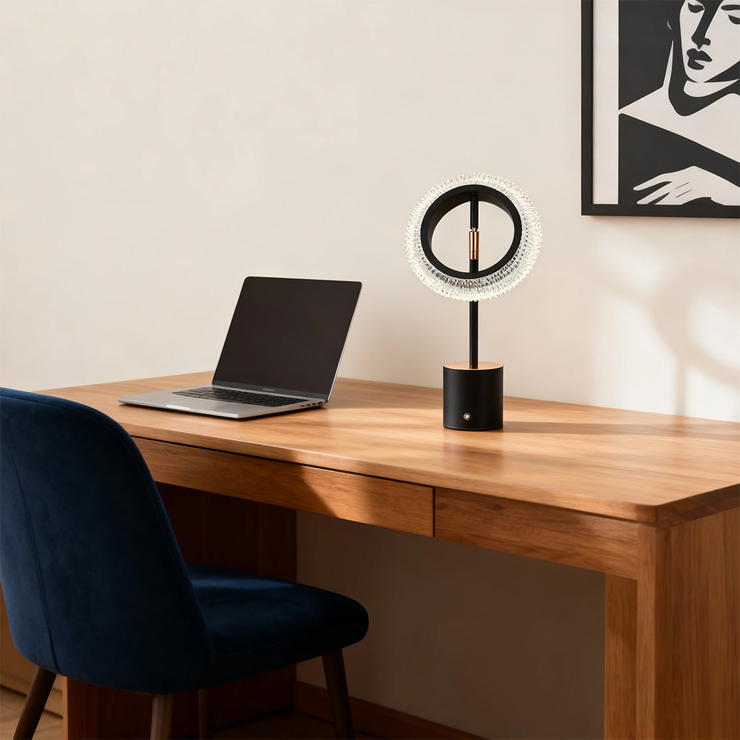 Modern black and white ring table lamp on a wooden desk, perfect for stylish home office or study area lighting.