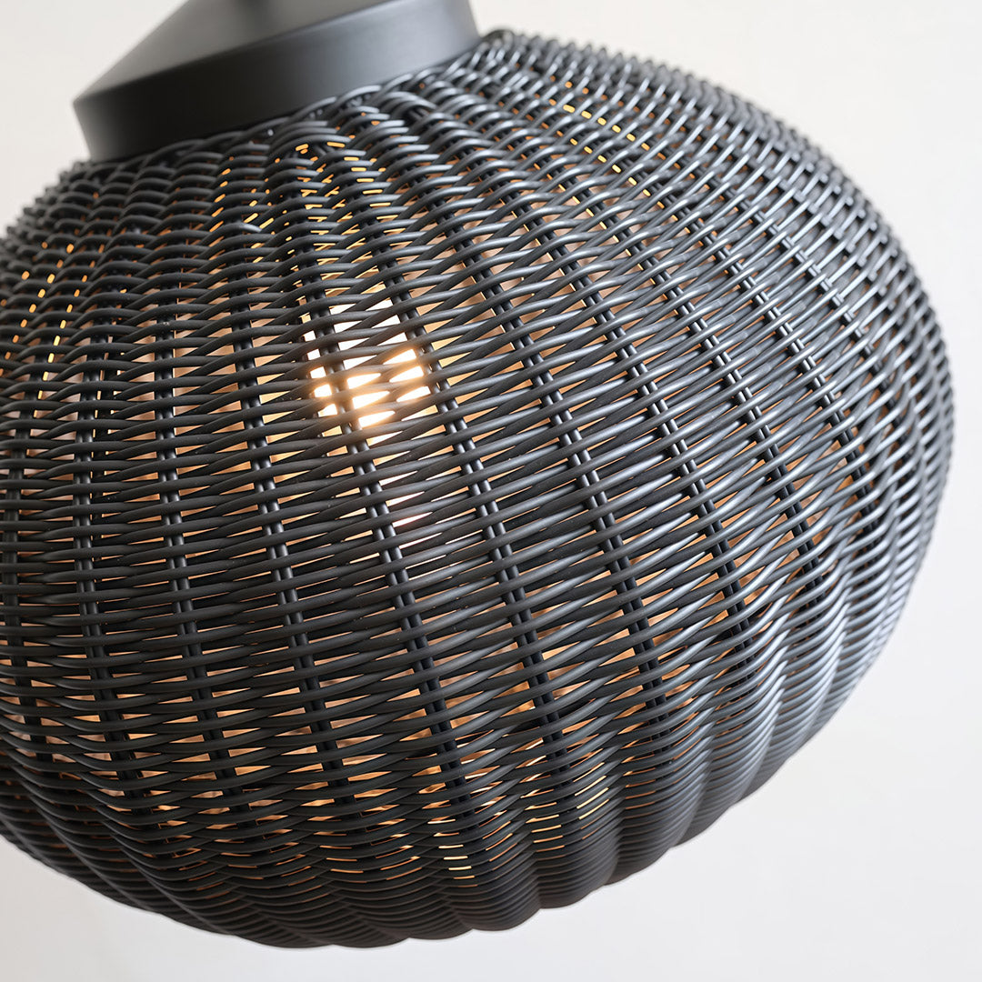 Black woven pendant light in a modern setting, bringing a natural, textural element to the interior design.