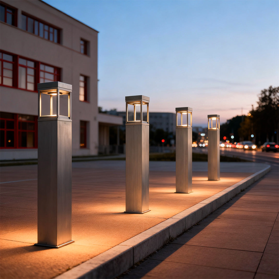 Row of modern bollard lights lining a contemporary walkway at dusk, creating balanced and elegant outdoor lighting.
