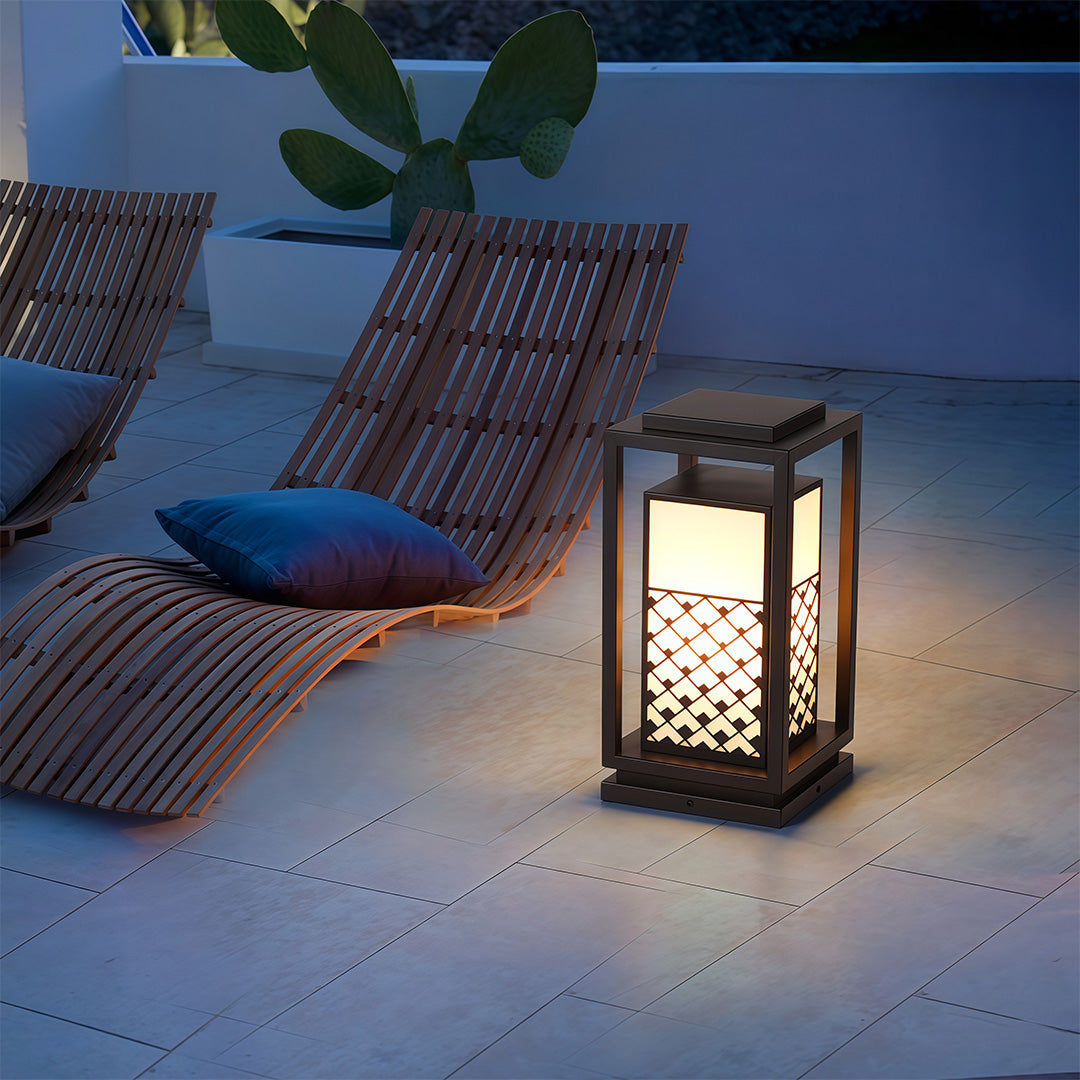 Bollard light fixture in a modern outdoor setting, creating a warm and inviting atmosphere along the garden path.