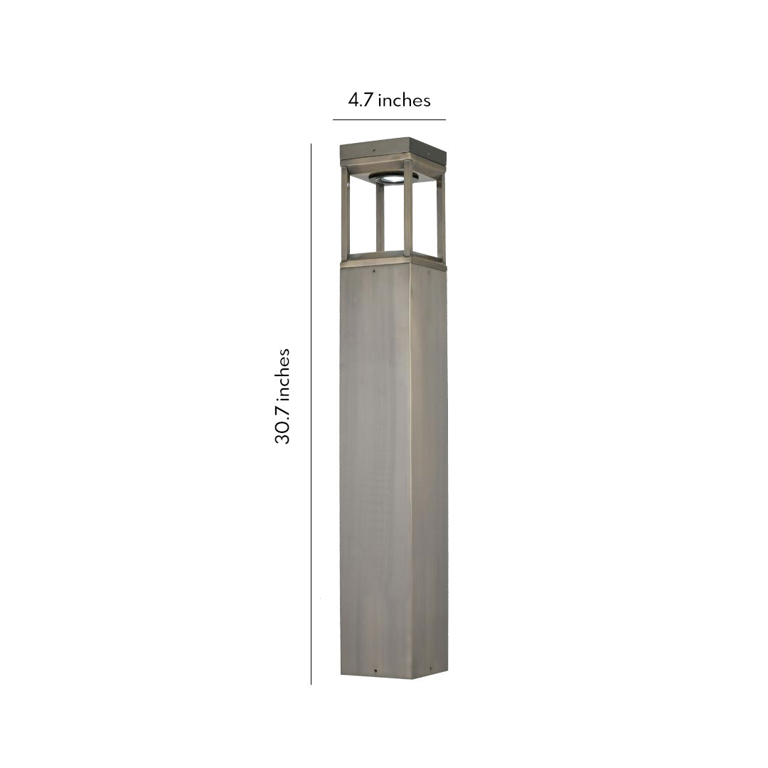 Modern bollard light with slim stainless steel body and soft LED glow, shown as a contemporary outdoor lighting fixture on a neutral background.