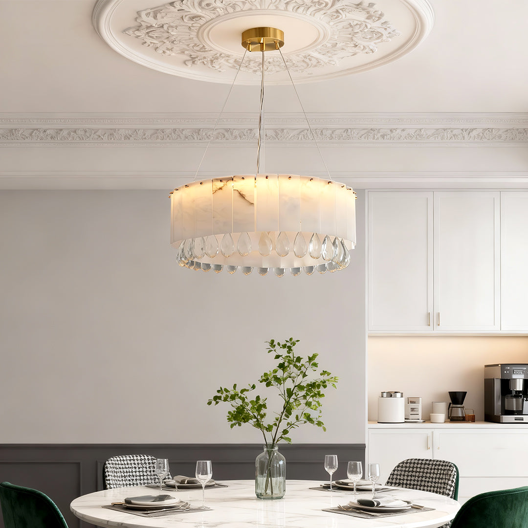Modern brass chandelier featuring an alabaster stone drum shade, offering luxury lighting and soft ambient illumination for sophisticated spaces.