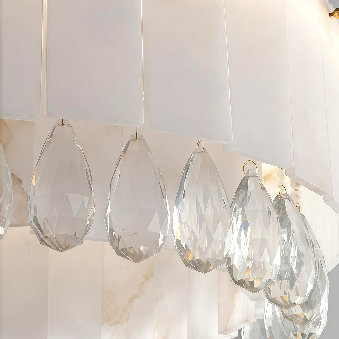 Close-up of curved brass chandelier frame with gold finish.