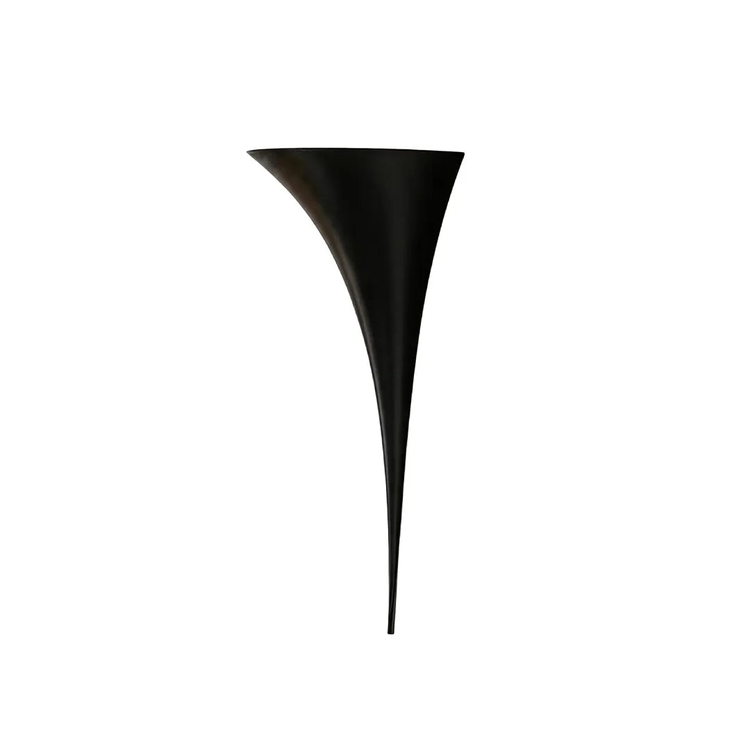 Modern brass wall sconce in a black finish isolated on a white background.