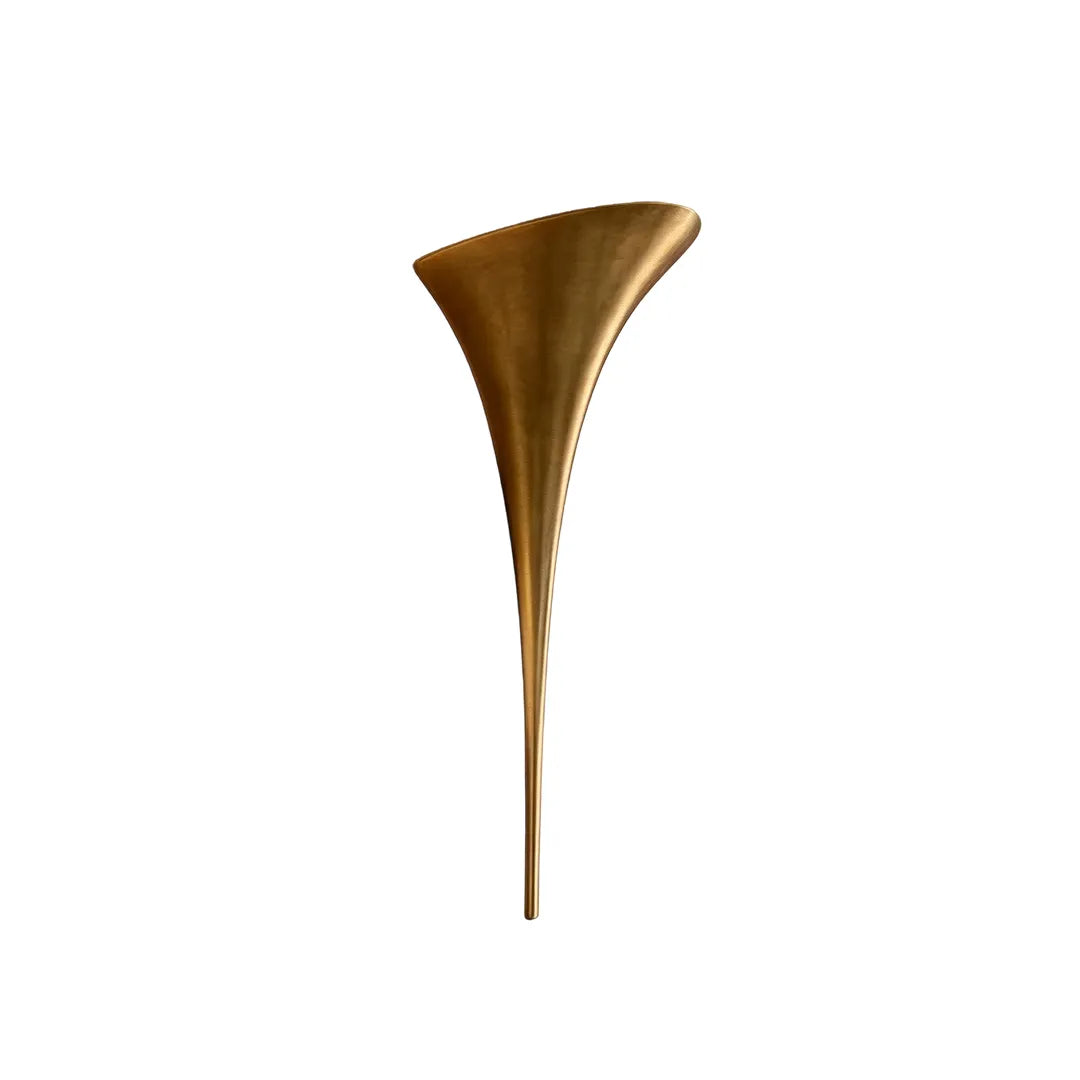 Modern brass wall sconce in a gold finish isolated on a white background.
