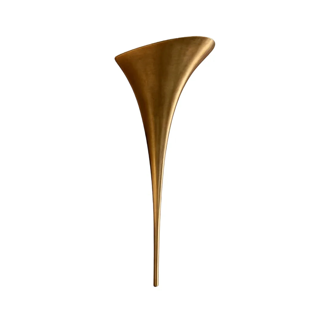 Modern brass wall sconce in a large gold finish version isolated on a white background.