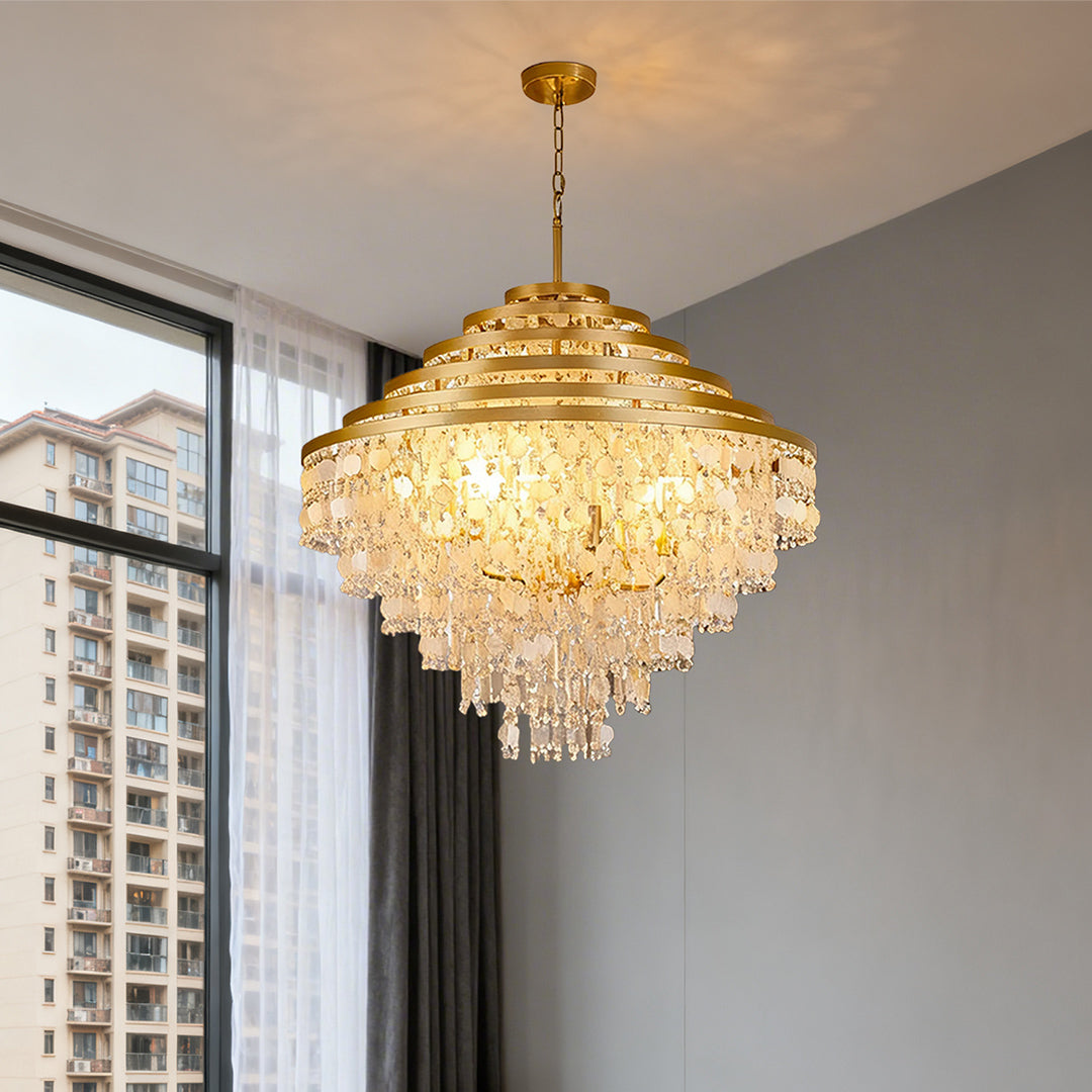 Glamorous gold-tiered crystal chandelier with hanging shells in a luxurious living room