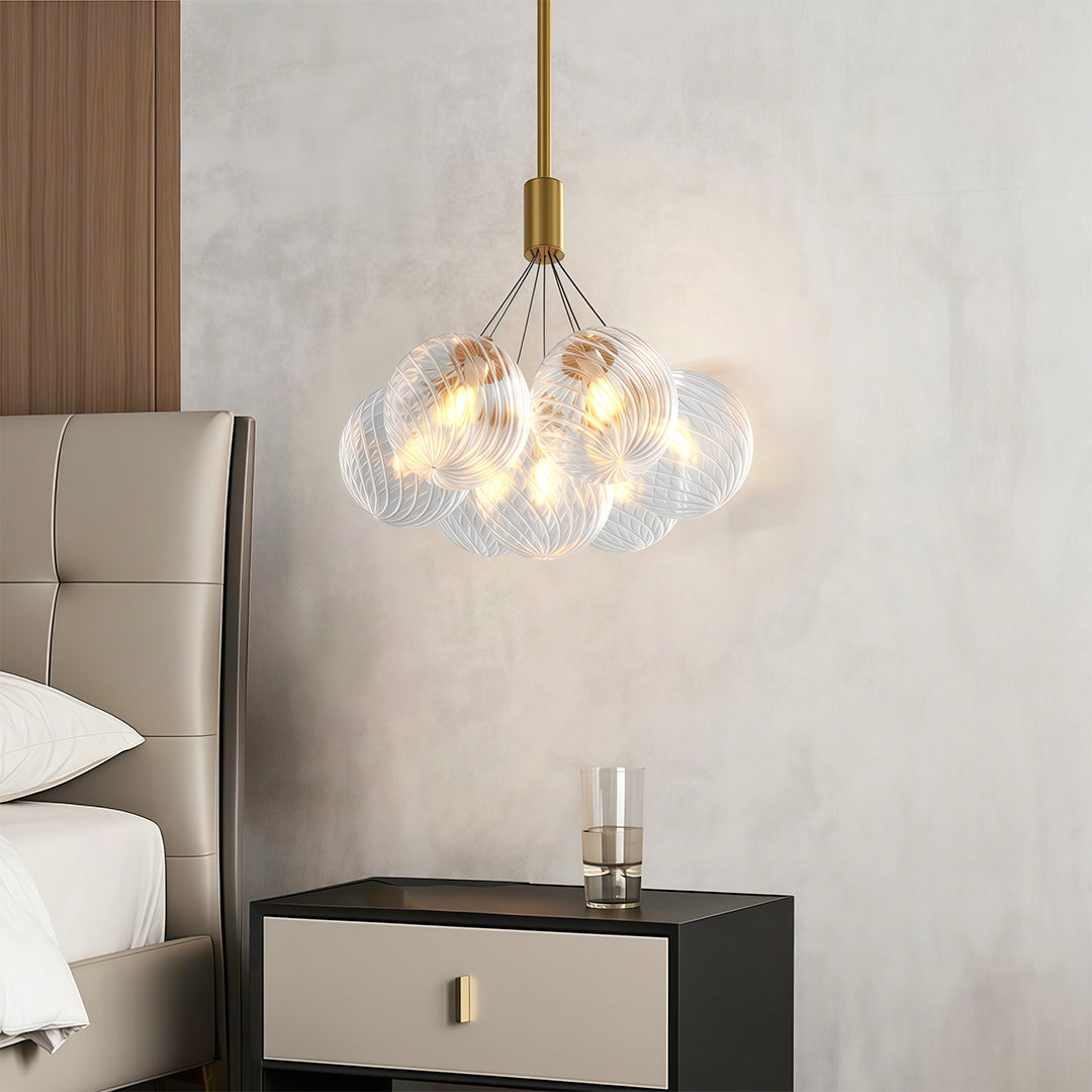 modern bubble chandelier hanging above a white dining table in a minimalist dining room