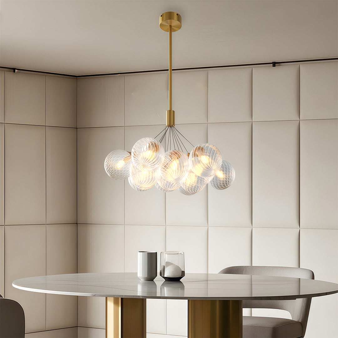 bubble glass chandelier hanging in a neutral-tone contemporary bedroom