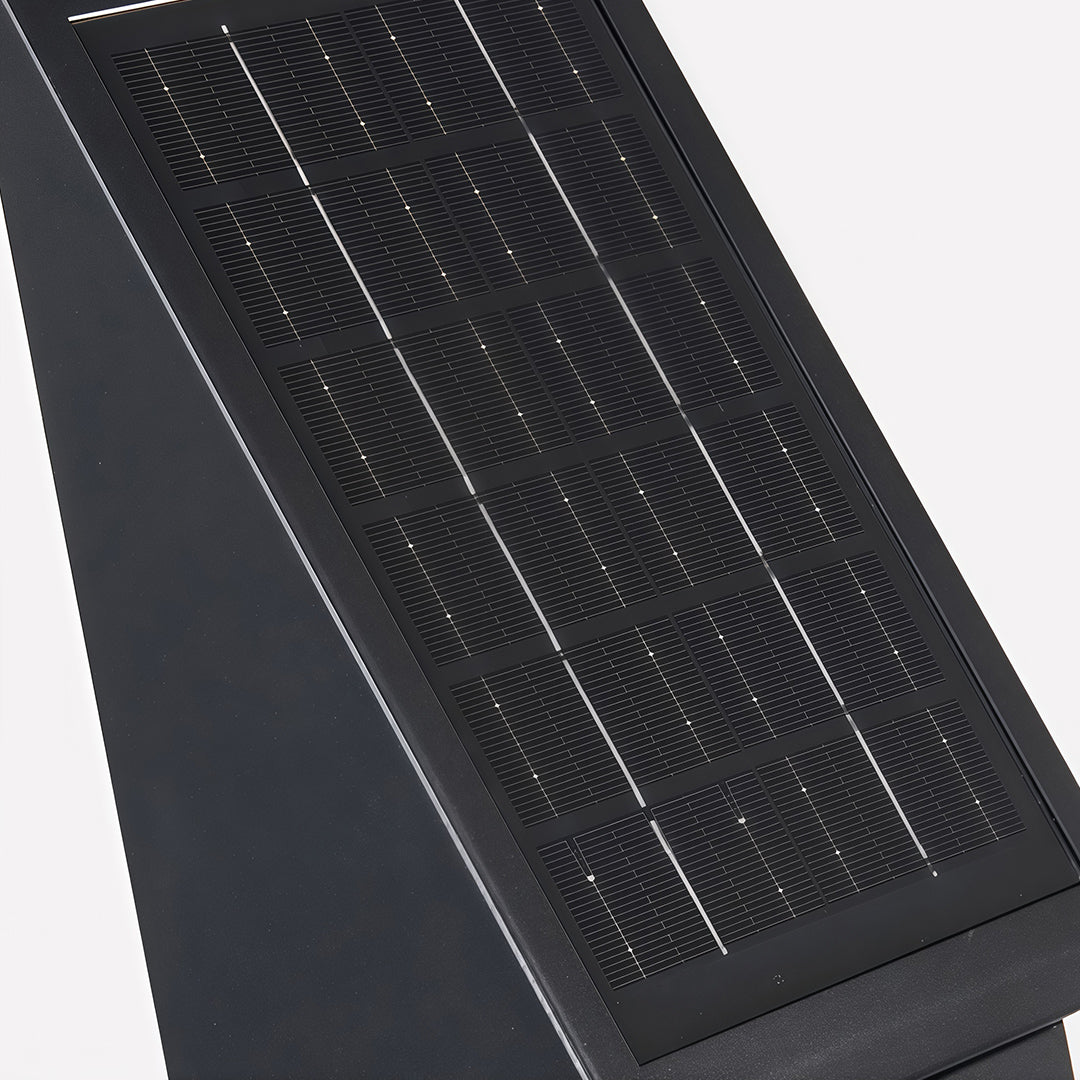 Black outdoor lighting sconce with a textured glass front, enhancing the exterior of a modern building.