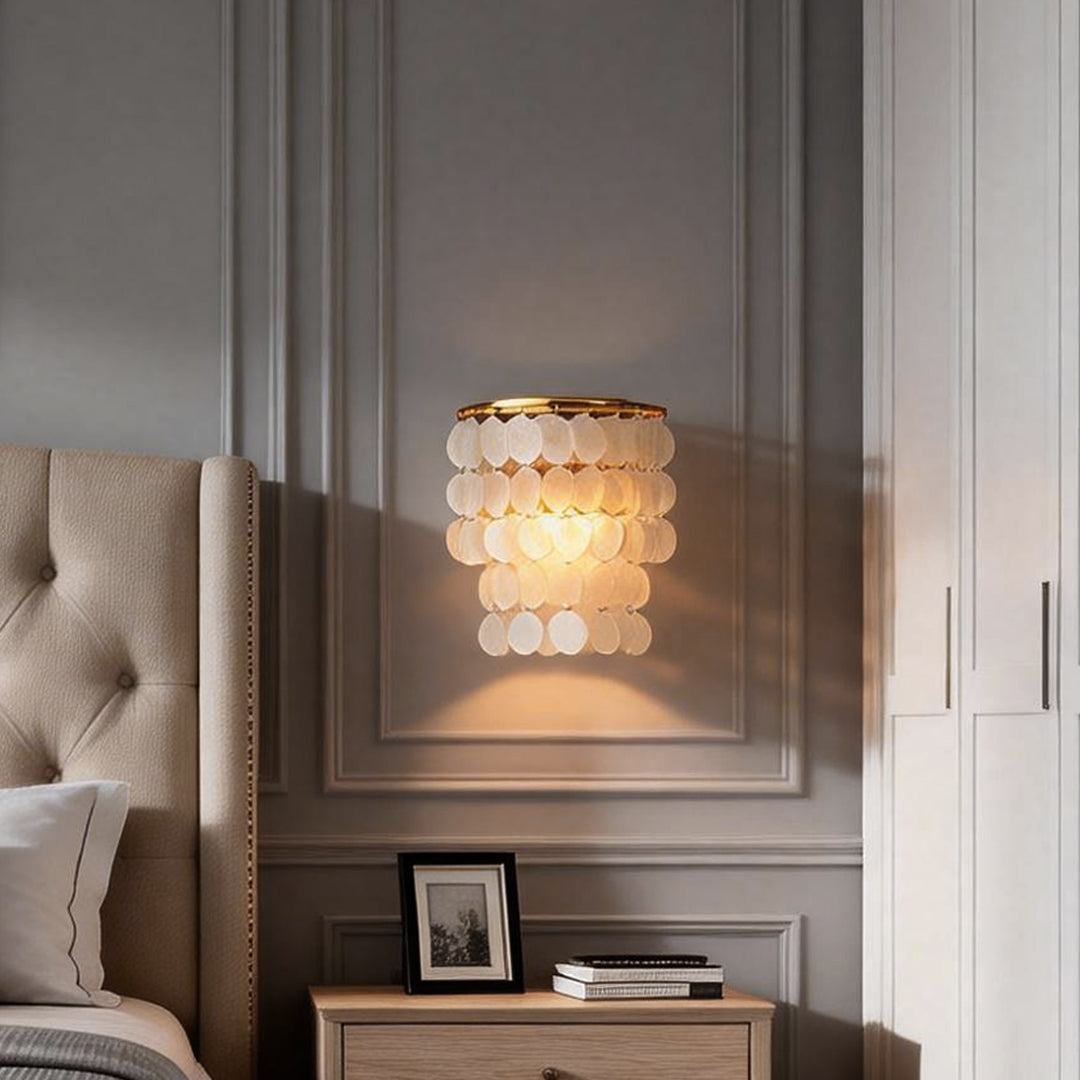 Contemporary capiz shell wall sconce with a golden accent, perfect for enhancing the beauty of any interior.