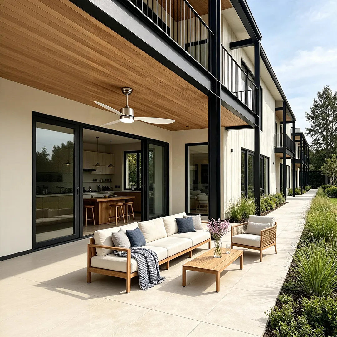 Modern ceiling fans with LED lights cooling a long outdoor terrace with wood ceiling and contemporary lounge furniture.