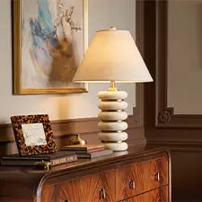 Modern ceramic table lamp displayed on a wooden dresser