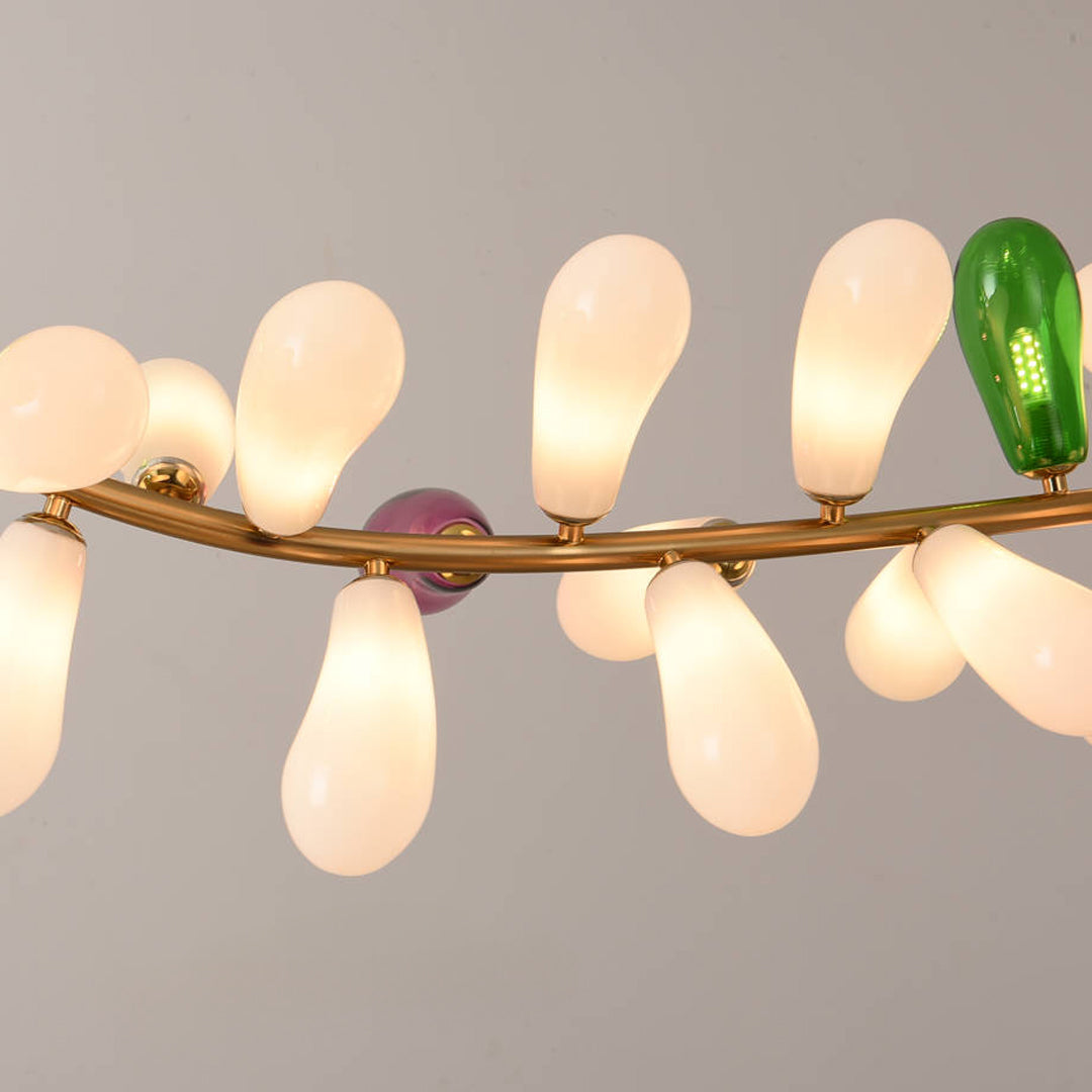 Detailed view of elongated glass shades arranged along a curved modern chandelier frame.