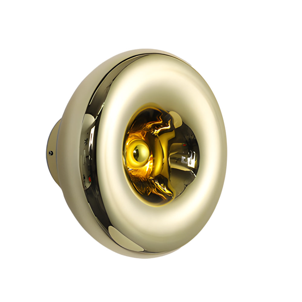 Modern chrome wall sconce with a golden interior, mounted in a contemporary living room.