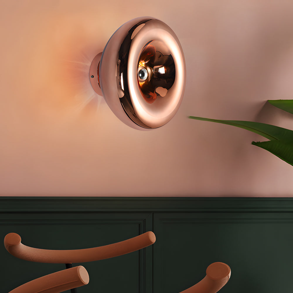 Modern chrome wall sconce with a minimalist design, enhancing a modern interior.