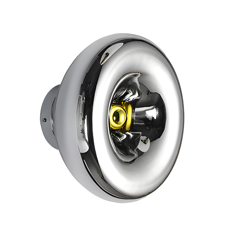 Modern chrome wall sconce with a round design, enhancing a modern bedroom.