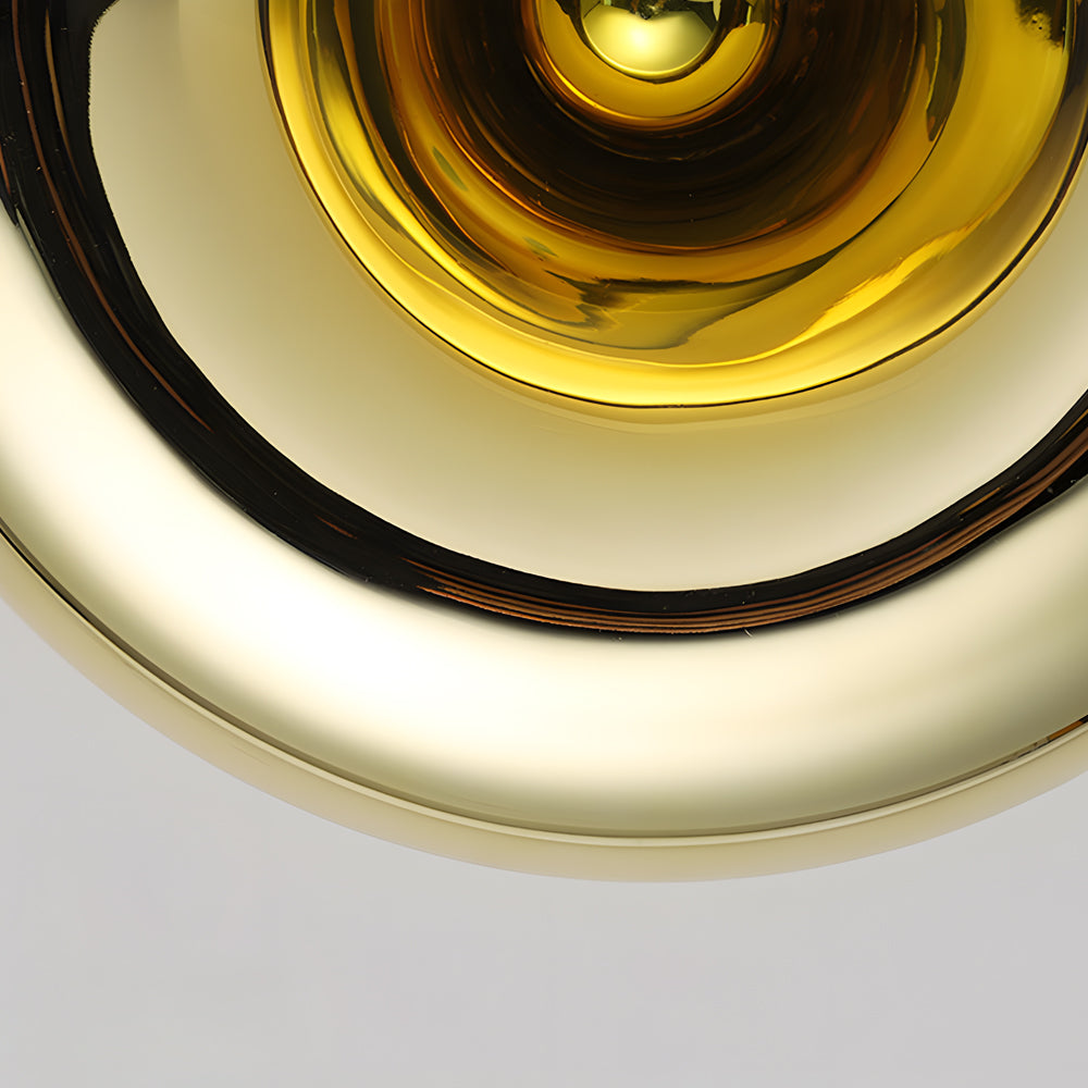 Modern chrome wall sconce with a sleek design, providing ambient lighting.