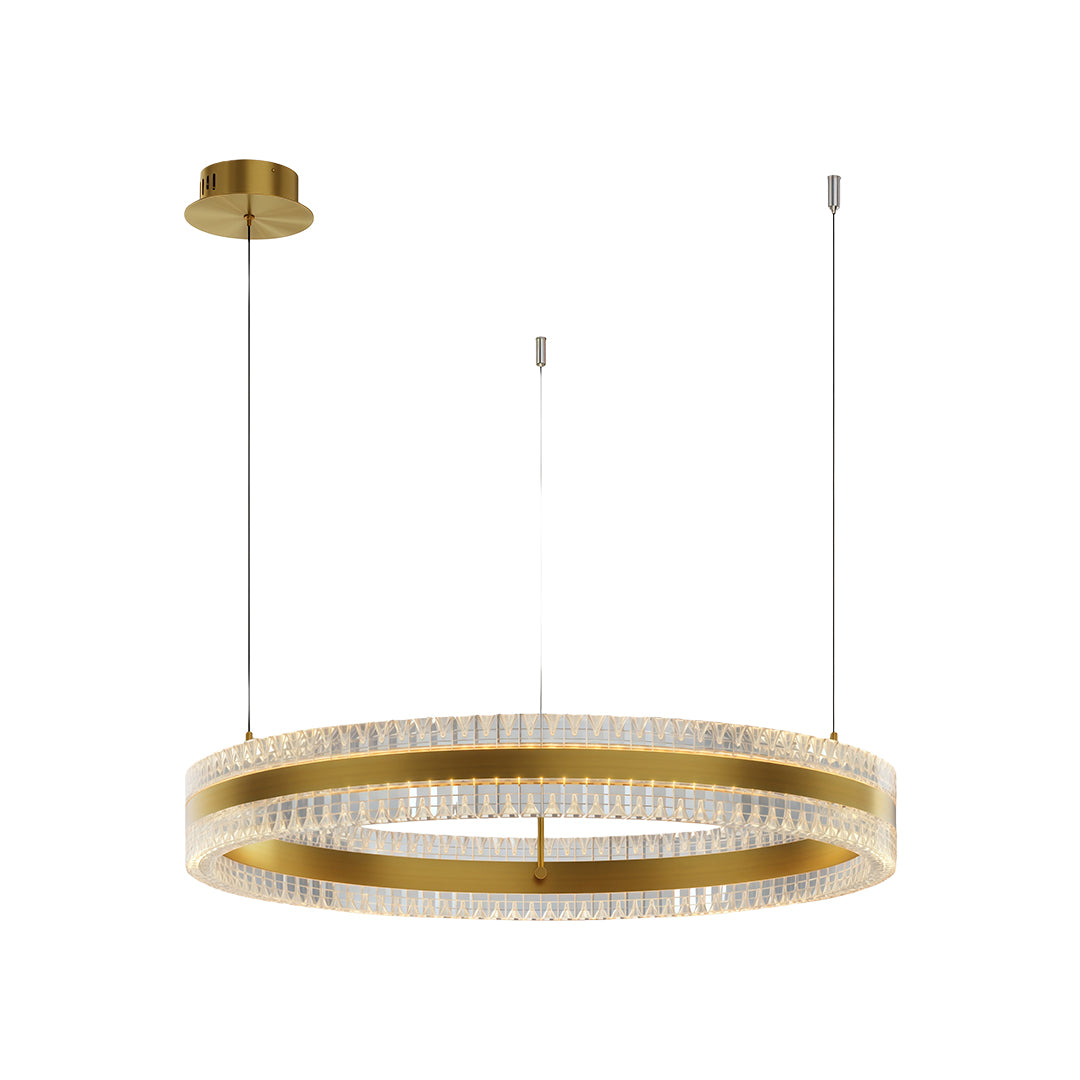 Dining room interior illuminated by a warm-tone modern circular chandelier with multiple crystal rings.