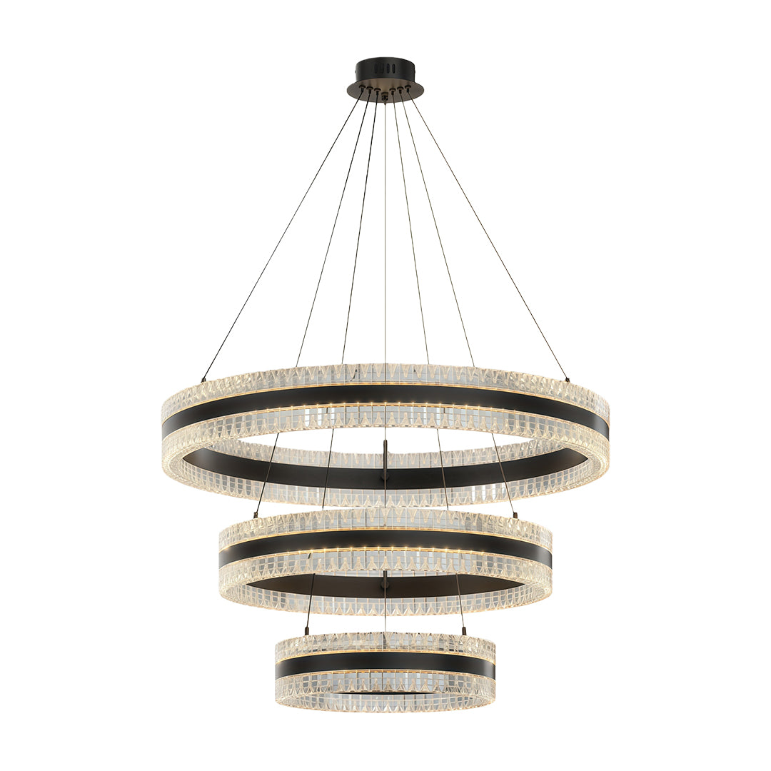 Modern circular chandelier with a gold finish, suspended above a dining table.