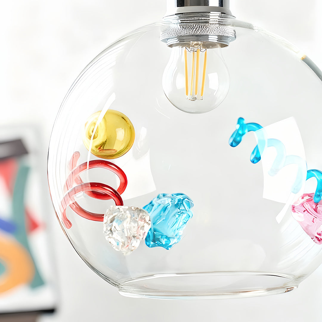 Modern clear coloured glass pendant lights with an exposed filament bulb and a contemporary metallic top.