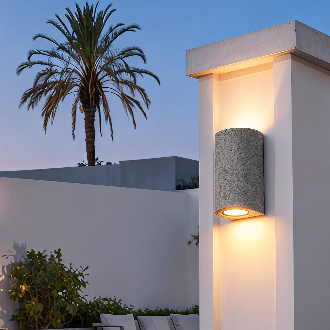 Contemporary outdoor installation showing up down wall lights illuminating a modern building column.