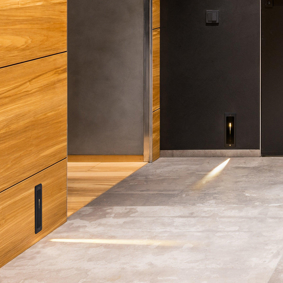 Modern concrete staircase with integrated recessed lighting creating dramatic downward illumination