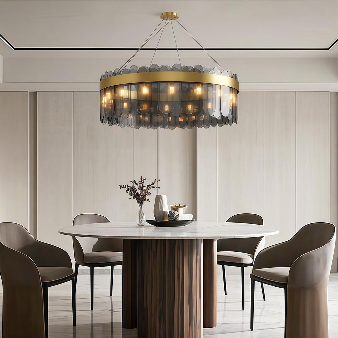 Modern copper chandelier above contemporary dining table with fluted base