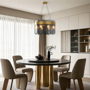 Modern luxury chandeliers lighting contemporary dining area with fluted table and curtains