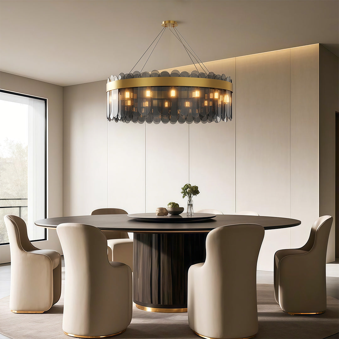 Modern luxury chandeliers above round dining table in bright neutral interior