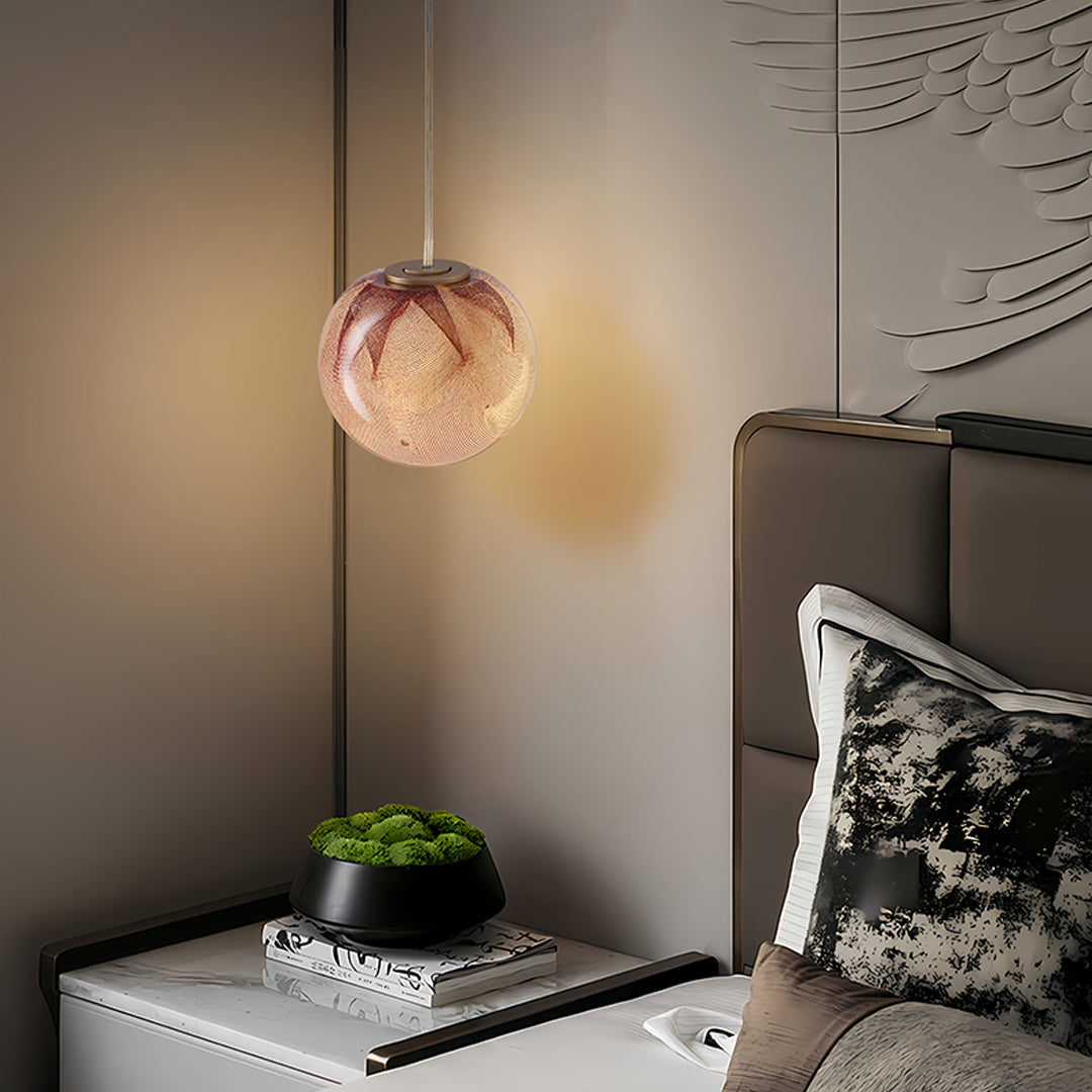 Stylish glass globe pendant lights suspended in modern interior with copper glass shade providing soft atmospheric illumination