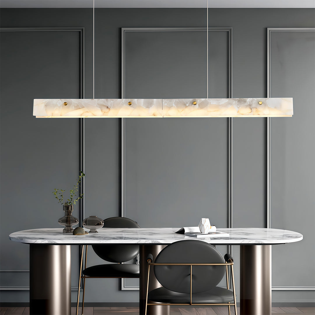 Modern copper metal pendant light with a marble accent, providing stylish illumination in a minimalist kitchen