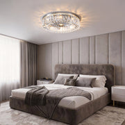 Modern crystal ceiling light installed in a luxury bedroom with soft ambient lighting.