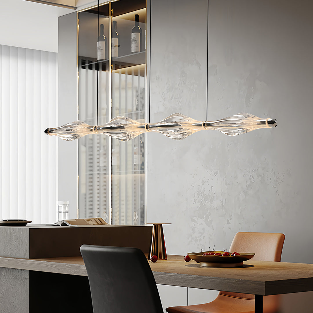 Modern crystal pendant lights for kitchen island with sleek design, hanging above a dining table in a luxurious space.