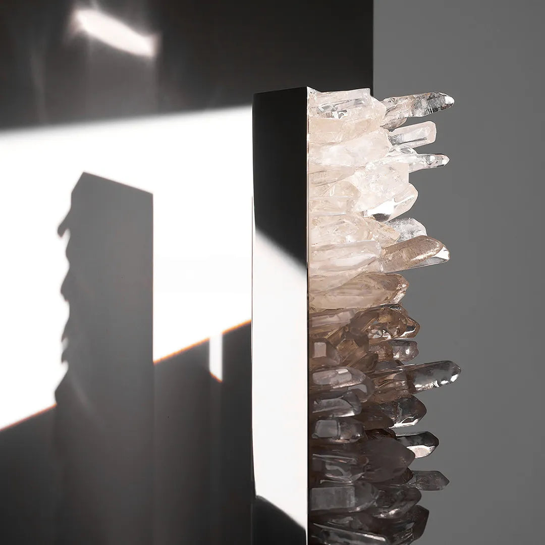 Modern crystal wall lights close-up showing the textured crystal edge and sleek metal body.