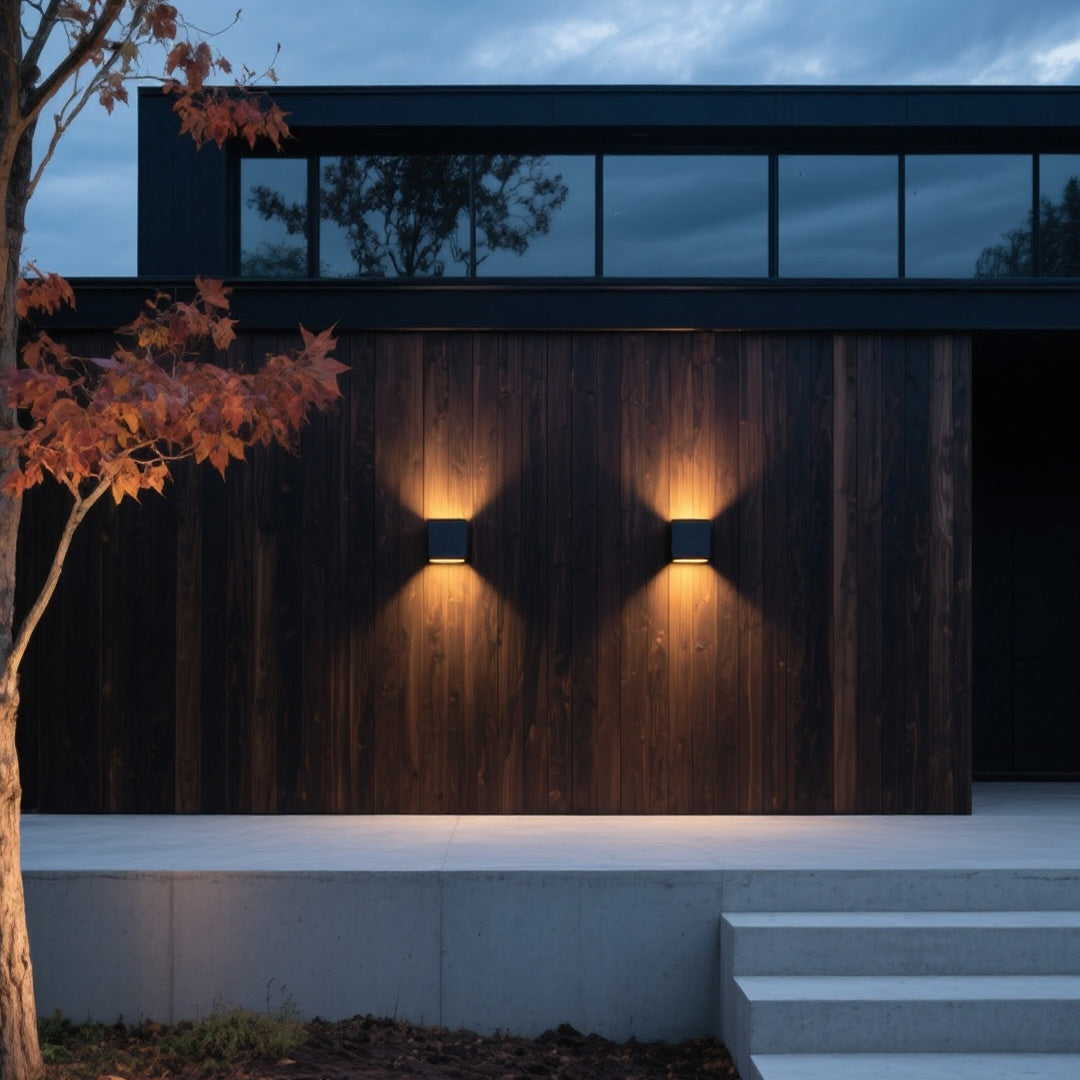 Modern dark wood siding facade accented by twin black Outdoor Wall Light Waterproof units creating warm light patterns.
