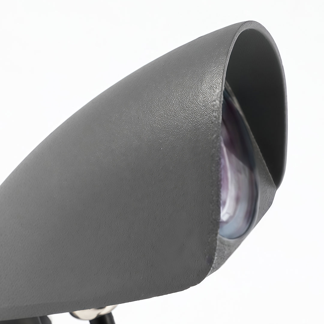 Modern decorative wall wash light with metallic finish and curved shield.