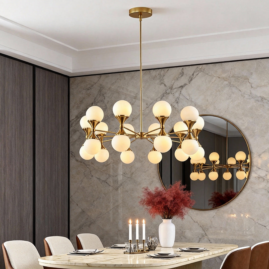 Modern dining space illuminated by bubble glass chandeliers against a stylish marble wall background.