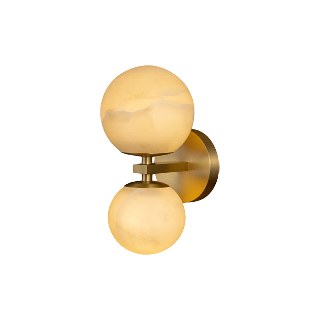 Modern double globe wall light with warm stone shades and brass base isolated on white background