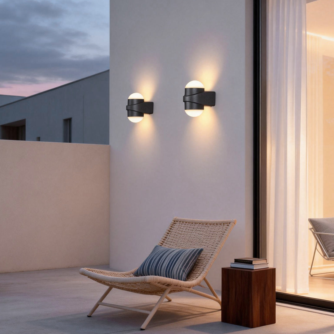 Modern double heads wall sconce illuminating a contemporary house entrance with warm directional light.