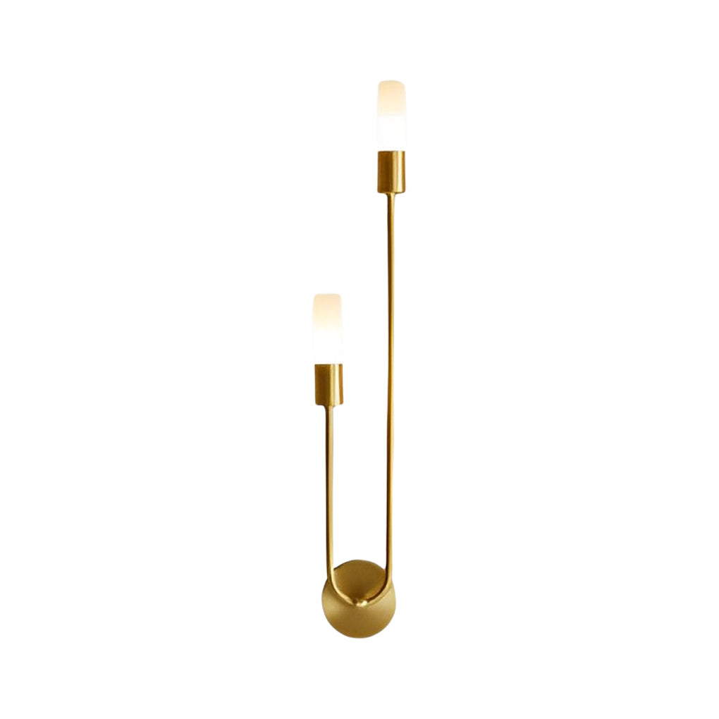 Modern double heads wall sconce with a gold finish, providing soft illumination in a bedroom.
