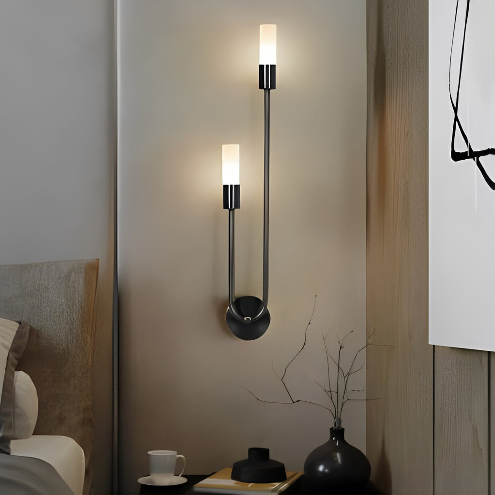 Modern double heads wall sconce with a minimalist design, providing warm light near a sofa.