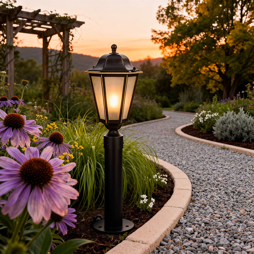 Modern exterior path lighting casting a soft glow on a flower-lined walkway during the evening hours.