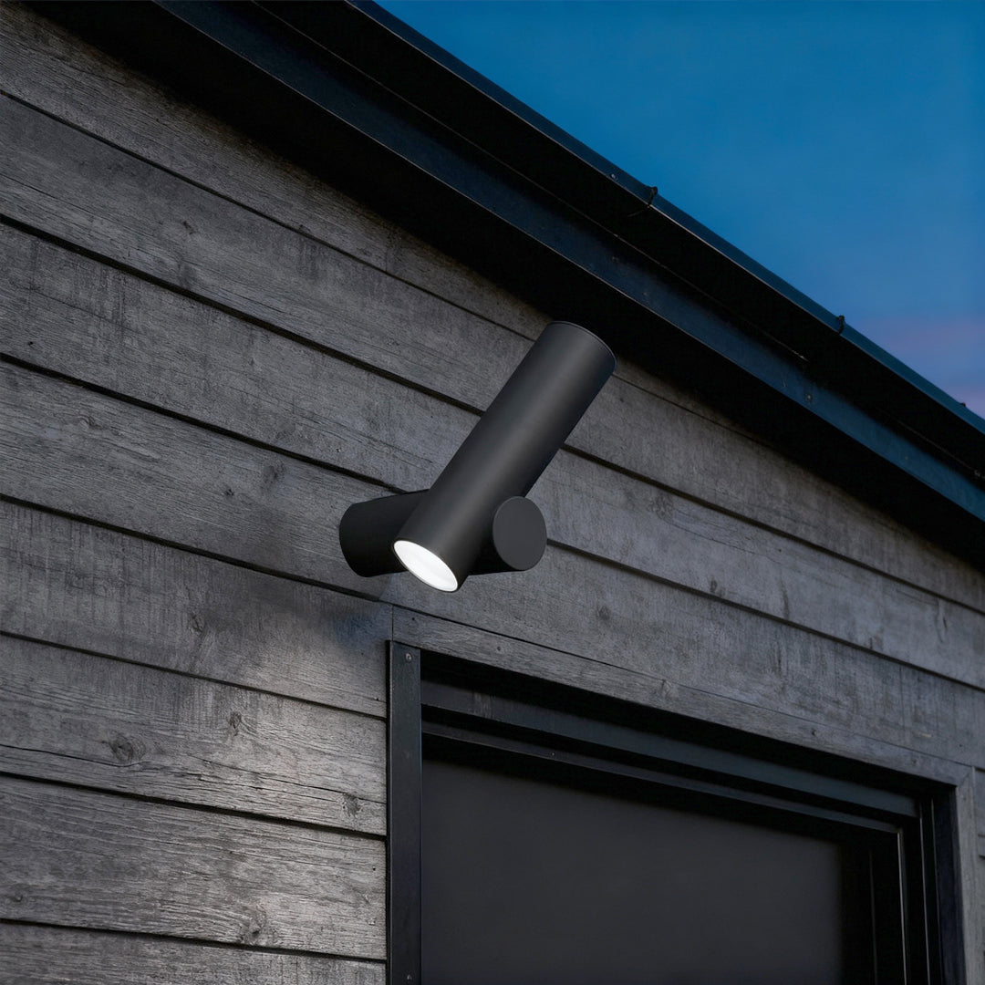 Contemporary spotlight wall lights installed on a textured exterior wall, providing directional outdoor lighting.