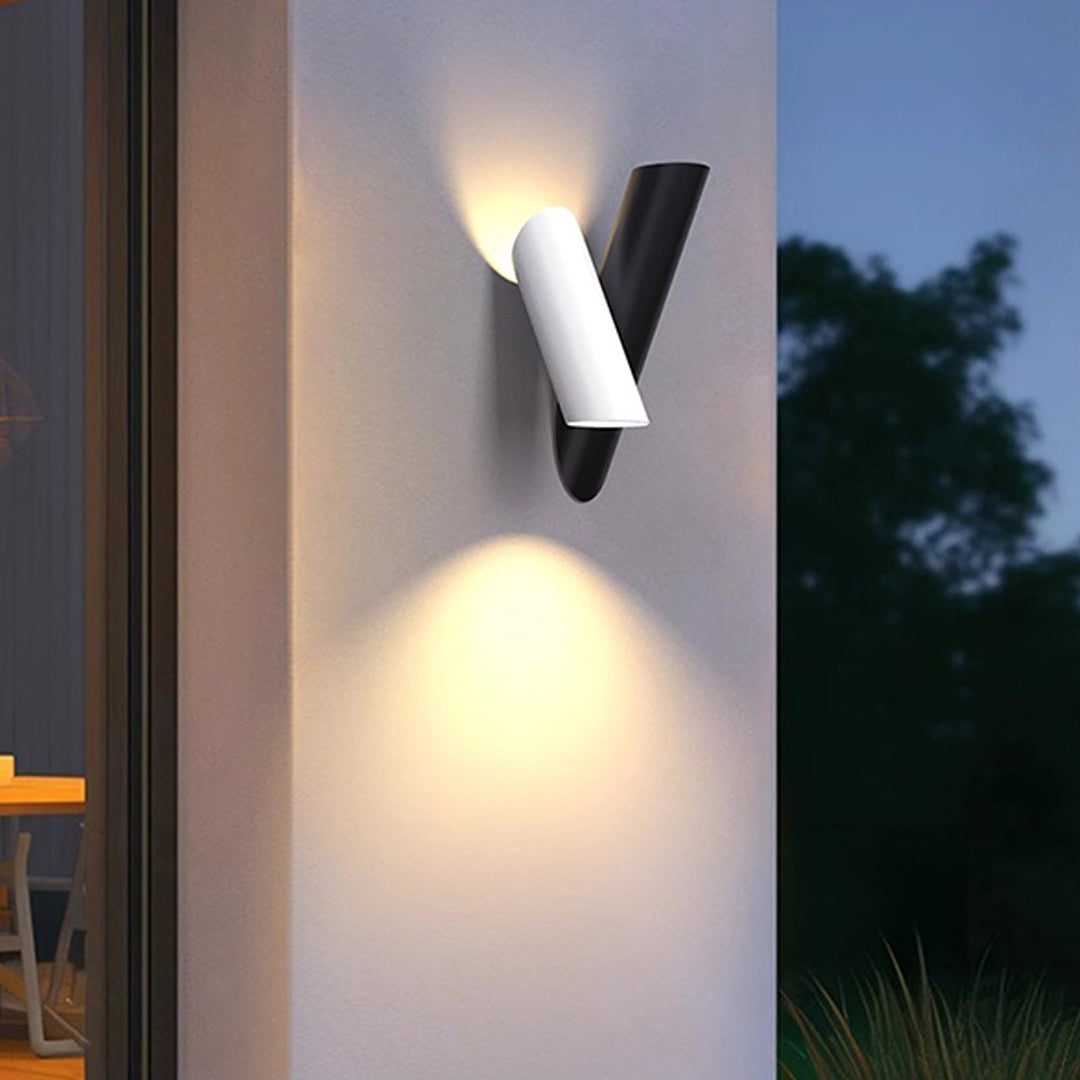 Modern up and down wall lights outdoor casting symmetrical beams on exterior house wall.