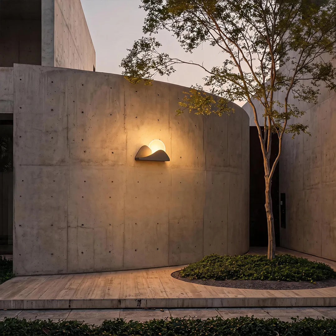 Modern exterior wall lighting illuminating a concrete garden wall with a soft ambient glow.