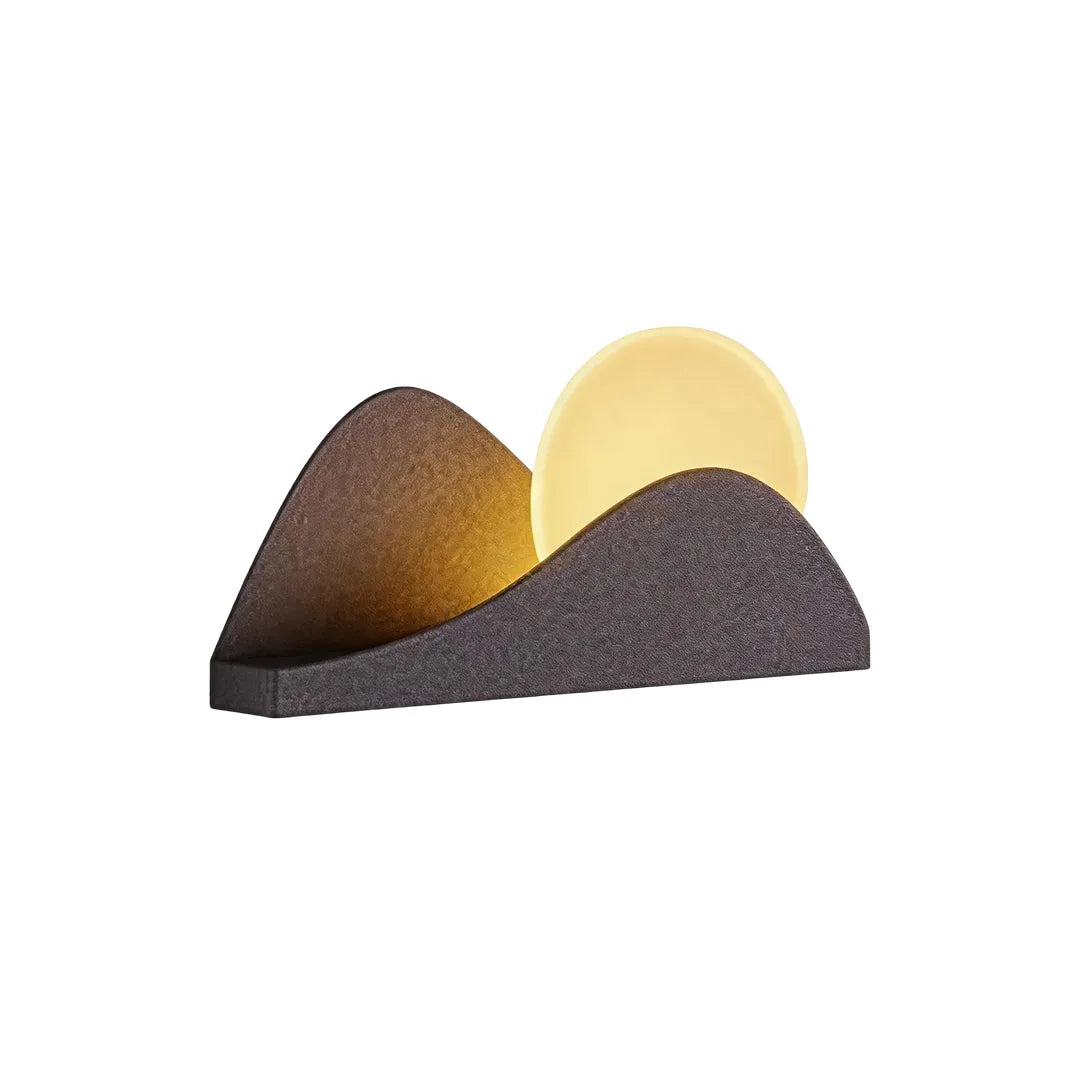 Modern exterior wall lighting with a sculptural dark finish and glowing circular LED accent.