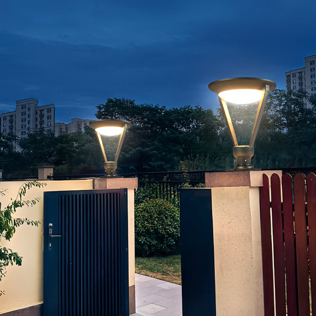 Modern flared external pillar lights providing bright, even illumination at the entrance gate and wall of a residential complex.
