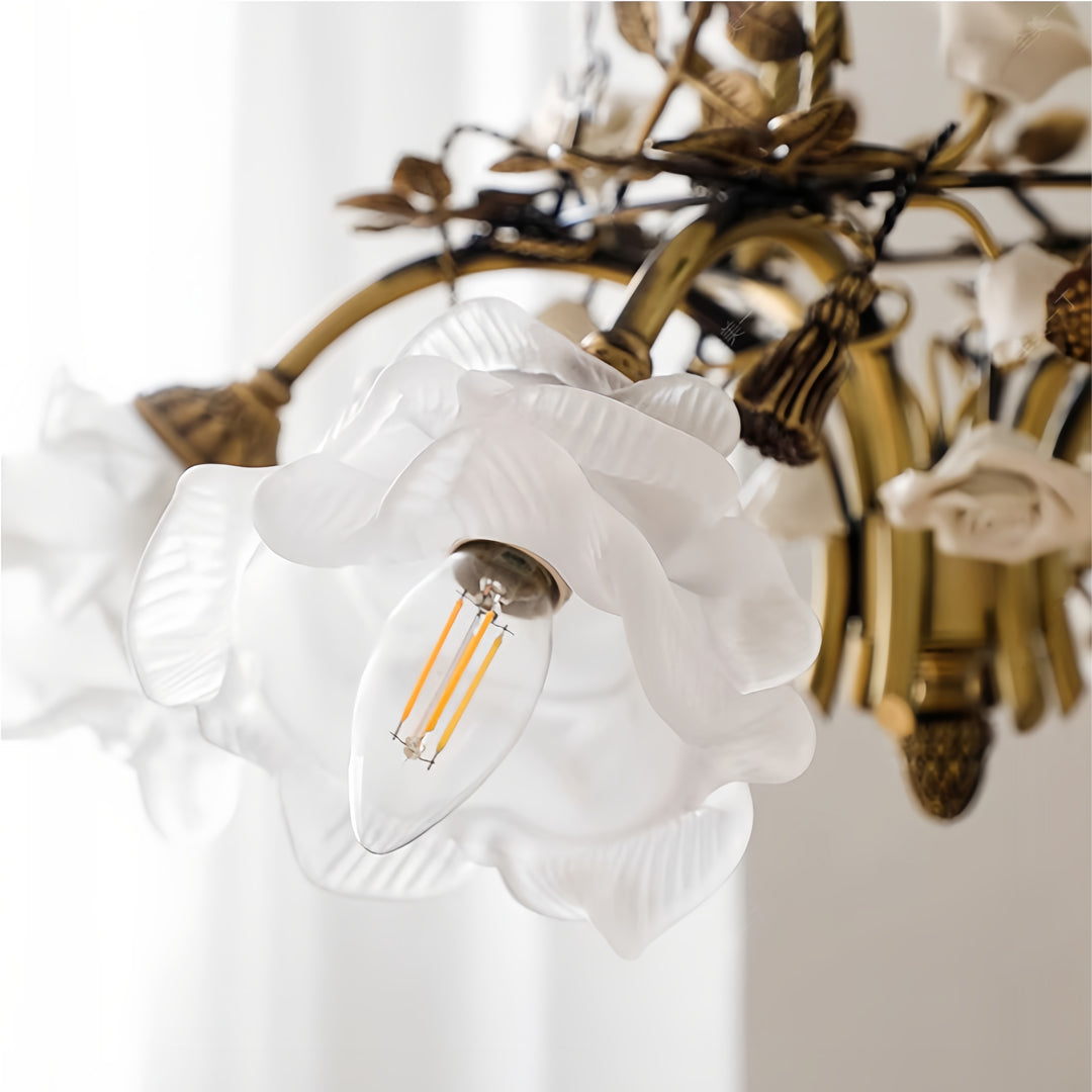 Close-up detail of modern flower chandelier showing intricate brass metalwork and frosted glass flower shade design